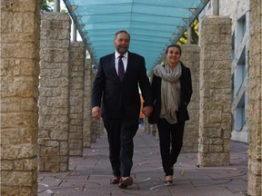 NDP leader Tom Mulcair and wife Catherine Pinhas makes their way to city hall in downtown Edmonton on Friday.