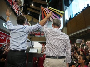 Liberal candidate retired lieutenant-general Andrew Leslie and Liberal Leader Justine Trudeau arrive at a rally Monday evening at The Shenkman Arts Centre in Orléans.