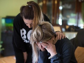 Tima Kurdi, right, aunt of late brothers Alan and Ghalib Kurdi, is comforted by friend Hoba Said, at her home in Coquitlam, B.C., on Thursday September 3, 2015. Alan, his older brother Ghalib and their mother Rehanna died as they tried to reach Europe from Syria. The uncle of the three-year-old Syrian boy whose lifeless body has put a devastating human face on the Syrian refugee crisis has assailed Canada's refugee process.