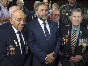 NDP leader Tom Mulcair poses for a photo with veterans during a campaign stop at the Royal Canadian Legion in Dartmouth, N.S. on Monday, Sept. 21, 2015.
