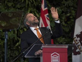 NDP Leader Tom Mulcair waves to the crowd on the upper levels of the atrium as he addresses a student audience during a campaign stop at the University of Ottawa on Tuesday, Sept. 22, 2015.