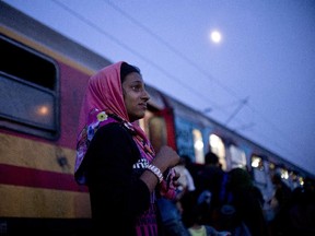 A Syrian girl cries after losing sight of her family while migrants and refugees board a train heading to Serbia near the Macedonian-Greek border on September  23, 2015. European Union leaders hold an emergency migration summit on September 23 amid a growing east-west split after ministers forced through a controversial deal to relocate 120,000 refugees.