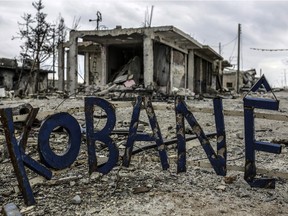 Destroyed buildings are seen around a sign that reads, ''Kobane''  in the Syrian Kurdish town of Kobane, also known as Ain al-Arab, on March 24, 2015.