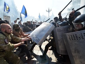 Activists of radical Ukrainian parties, including the Ukrainian nationalist party Svoboda (Freedom), clash with police officers in front of the parliament in Kiev on August 31, 2015. At least 20 were wounded in clashes outside parliament in Kiev after lawmakers gave initial approval to constitutional changes granting more autonomy to pro-Russian separatists in eastern Ukraine.