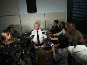 Toronto Police Services Superintendent Bryce Evans, centre, speaks to the media regarding the investigation into the AshleyMadison.com breach during a press conference in Toronto on Monday, August 24, 2015.