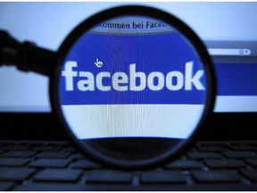 A magnifying glass is posed over a monitor displaying a Facebook page in Munich on Oct. 10, 2011. Facebook is being more proactive in ensuring its users fully understand their privacy settings and who can see their posts. THE CANADIAN PRESS/AP, dapd, Joerg Koch 
stock photo
STK_