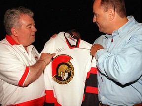 Max Keeping, left, joins Robert Lendvai to give out an Ottawa Senators sweater signed by Wade Redden at a fundraising event in 1998.
