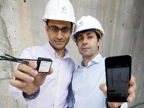 Aali Alizadeh, Giatec Scientific CEO, left, and Pouria Ghods, president, pose with the smart sensor, on left, they invented that can be imbedded in concrete to monitor it as it cures with a smart device like an iPhone, on right.