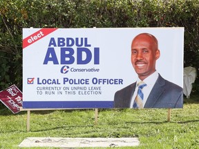 Abdul Abdi signs in Ottawa West-Nepean at the corner of Baseline and Greenbank, October 08, 2015.