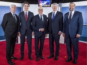 Bloc Quebecois leader Gilles Duceppe, left to right, Liberal leader Justin Trudeau, journalist Pierre Bruneau, Conservative leader Stephen Harper and  NDP leader Tom Mulcair poses for photos before the start of a French-language debate broadcast by Quebec's TVA network in Montreal on Friday, Oct. 2, 2015.