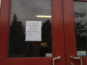 Many schools that have unlocked their doors have posted signs reminding visitors to check in a the office, such as this one at Broadview Avenue Public School.