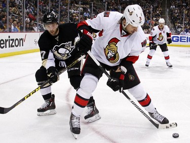 Ottawa Senators' Marc Methot (3) clears the puck from the corner in front of Pittsburgh Penguins' Bryan Rust (17) during the second period.