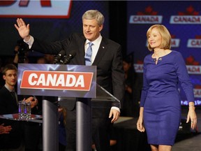 Prime Minister Stephen Harper and wife Laureen take the podium to speak to supporters after hearing election day results in Calgary on Monday.