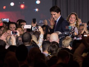 Canadian Liberal Party leader Justin Trudeau and his wife Sophie walk off stage in Montreal on October 20, 2015 after winning the general elections.