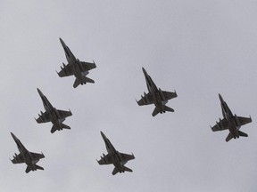 CF-18 Hornets fly in formation on their the departure for Operation IMPACT, in Cold Lake, Alberta on Tuesday October 21, 2014. The Canadian CF-18 Hornets were making their way to Kuwait, to join the fight against the Islamic State of Iraq and Syria.