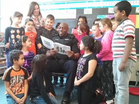 Constable Darren Joseph from the Ottawa Police is reading "Invisibill" to a Grade 3/4 class at Severn Avenue Public School.
