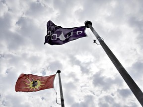 The Mohawk and Five Nations flags fly outside the former site of a Canadian border post in the middle of Akwesasne Mohawk reserve, photographed Wednesday, July 28, 2010.