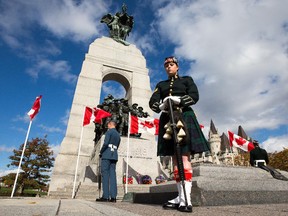 Cpl Casey O'Keefe stands on guard during a memorial service held at the National War Memorial on Thursday as Canada marks the one-year anniversary of the Oct. 22, 2014 attacks on Parliament Hill and at the Cenotaph.  The event honoured the sacrifices of Warrant Officer Patrice Vincent and Corporal Nathan Cirillo, and the bravery of the first responders. Assignment - 121929 Photo taken at 11:39 on October 22. (Wayne Cuddington/ Ottawa Citizen)