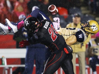 David Hinds of the Ottawa Redblacks tackles Nick Moore of the Winnipeg Blue Bombers during first half CFL action.