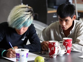 Two young people at the Armoury Resource Centre in Edmonton, which has a bold strategy to eliminate homelessness.