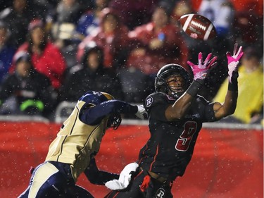 Ernest Jackson of the Ottawa Redblacks can't handle the touchdown pass as he is taken down by  Demond Washington of the Winnipeg Blue Bombers during first half CFL action.