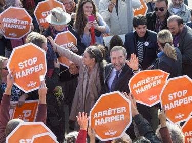 NDP Leader Tom Mulcair, accompanied by wife Catherine Pinhas, waves to supporters as he arrives at a rally in Saskatoon on Monday, October 12, 2015. THE CANADIAN PRESS/Ryan Remiorz