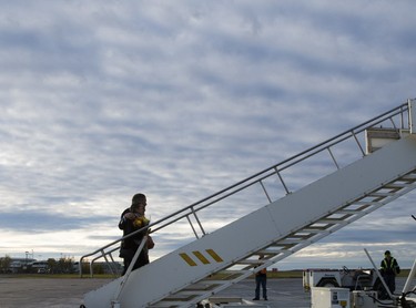 NDP Leader Tom Mulcair and wife Catherine Pinhas board the party campaign plane for a flight to Toronto on Monday, October 12, 2015, in Saskatoon. THE CANADIAN PRESS/Ryan Remiorz