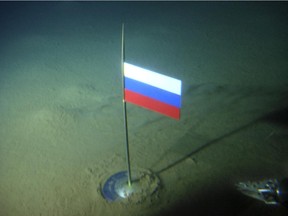 FILE - In this Thursday, Aug. 2, 2007 file made available by the Association of Russian Polar Explorers on Wednesday, Aug. 8, 2007, photo a titanium capsule with the Russian flag is seen seconds after it was planted by the Mir-1 mini submarine on the Arctic Ocean seabed under the North Pole during a record dive. Russia says it has submitted its bid for vast territories in the Arctic to the United Nations. The Foreign Ministry said Tuesday, Aug. 4, 2015, that Russia is claiming 1.2 million square kilometers (over 463,000 square miles) of Artic sea shelf.  (AP Photo/Association of Russian Polar Explorers, file)
0805 fo arctic