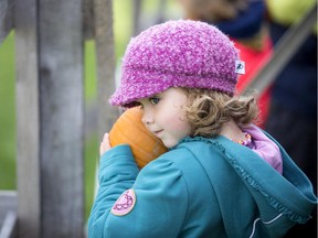 Four-year-old Charlotte Raicevic gives her pumpkin one last hug before it flies across the field during the annual Smashing Pumpkins event at the Cumberland Heritage Village Museum on  Saturday, Oct. 3, 2015.
