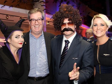 From left, BOOM 99.7 radio host Wendy Daniels as Maleficent with Mayor Jim Watson and Beacon Hill-Cyrville Ward Councillor Tim Tierney as a 1970s-era pilot and his wife, Jenny, as his stewardess, at the Halloween-themed ARTinis, an annual benefit soirée for the AOE Arts Council, held at the Shenkman Arts Centre on Thursday, October 29, 2015.