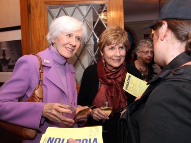 From left, Marsha Skuce and Jerry Grey get ticketed by Erin Edwards as part of a gimmick to raise awarness for The Match International Women's Fund at a private event hosted Wednesday, October 28, 2015, for the organization and its patron, Shirley Greenberg.