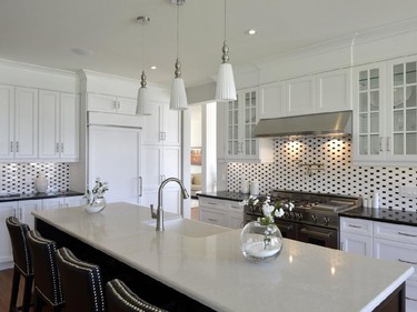 Deslaurier Custom Cabinets, HN Homes and Leonhard Vogt Design won a second kitchen award, this one in the category of production kitchen, 161 sq. ft. or more, for an elegant black and white design in the Winfield single-family home.