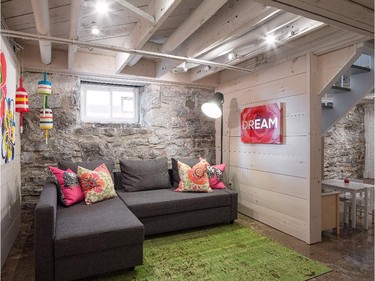 Basement renovation, $74,999 and under: Just Basements transformed a cellar into a living space with character by making use of the original stone foundation, which was restored, and creating a neo-industrial look.