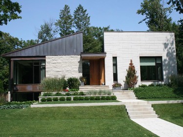 Designed by architect Barry Hobin, this modern home was meant to accommodate the shifting needs of the owners. A large family room and gym make the spacious and bright lower level a perfect spot for older children, while the convenient placement of essential amenities on the main level allows the home to double as an ideal place to retire. The design makes optimal use of natural light inside and a putting green, large entertainment space, lap pool and hot tub offer maximum outdoor enjoyment. Tour decorators: Mood Moss Flowers.