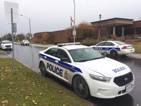 Police cars outside College Catholique Franco-Ouest on Thursday.