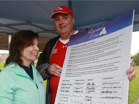 Gordon and Kathleen Stringer pose with Rowan's Law petition during media event at Ken Ross Park in Barrhaveno n Sept. 12.