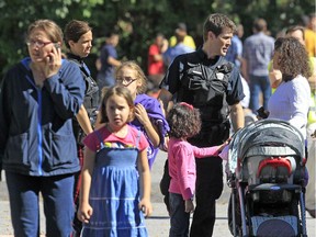 Parents retrieve their kids after a gunman entered D. Roy Kennedy Public School on Thursday, Sept. 26, 2013.
