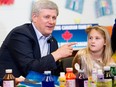 A young arts student looks unconvinced by Prime Minister Stephen Harper's pledges, during a visit to an arts class in Vaughan, Ontario, in 2014.