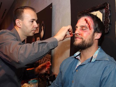 How's that for a makeover? From left, Michel Pennington, president of On Scene Fx professional makeup services, gives Jordan Rogers a gory look at the Halloween-themed ARTinis, an annual benefit soirée for the AOE Arts Council, held at the Shenkman Arts  Centre on Thursday, October 29, 2015.