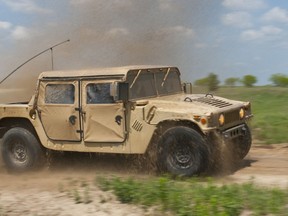 Soldiers with the 7th Mobile Public Affairs Detachment drive their Humvee through a water hazard on Fort Hood Training Area 11-12, April 23, 2014. (U.S. Army photo by Sgt. Ken Scar, 7th Mobile Public Affairs Detachment)