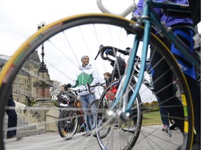 Imam Mohamad Jebara, centre, gets ready to ride in the Cycling Cleric's Challenge, a 14 km challenge between faith community group leaders to raise funds for affordable housing  in Ottawa, on Parliament Hill on Sunday, October 18, 2015. Justin Tang/Ottawa Citizen