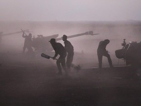 Syrian army personnel load howitzers near the village of Morek in Syria. The Syrian army has launched an offensive this week in central and northwestern Syria aided by Russian airstrikes.