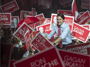 Liberal Leader Justin Trudeau greets supporters as he takes the stage during a rally Sunday, October 4, 2015 in Brampton, Ont.