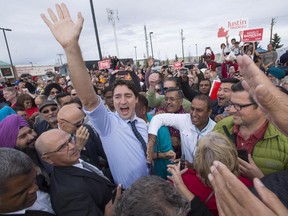 Liberal Leader Justin Trudeau makes his way through a crowd of supporters outside a rally,  Sunday, October 18, 2015 in Calgary.