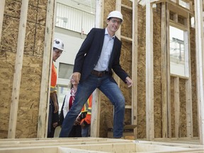 Liberal Leader Justin Trudeau walks into a house under construction during a campaign event at a trade school Thursday, October 8, 2015 in Vaughan, Ont.