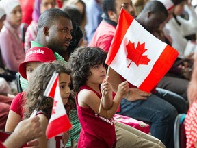 New Canadians take the citizenship oath during a special Canada Day ceremony held at the Canadian Museum of History in Gatineau in 2014.