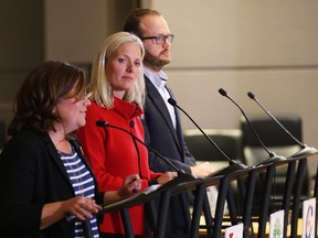 From left, Emilie Taman, NDP, Catherine McKenna, Liberal, Jean-Luc Cooke, Green Party, and an empty Conservative Party podium at the local issues debate at City Hall, Oct. 5, 2015.