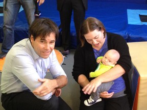 Ontario health minister Eric Hoskins meets a baby born with the aid of IVF, before announcing a new program to fund the fertility treatment for thousands of people.