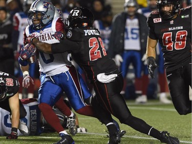 Montreal Alouettes' Stefan Logan runs the ball as Ottawa Redblacks' William Powell (29) defends during first half CFL action.