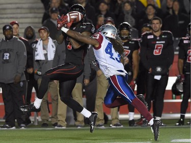 Montreal Alouettes' Terry Johnson breaks up a pass to Ottawa Redblacks' Maurice Price (7) during first half CFL action.